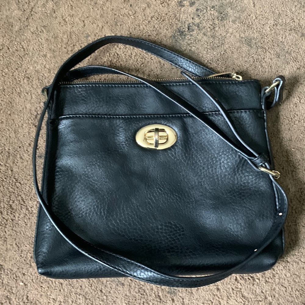 Coach purse. Small to medium size. 3 zippers and 1 clasp.